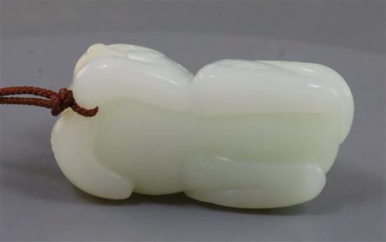 A Chinese white jade figure of a recumbent lion-dog, possibly 18th century, 5.9cm